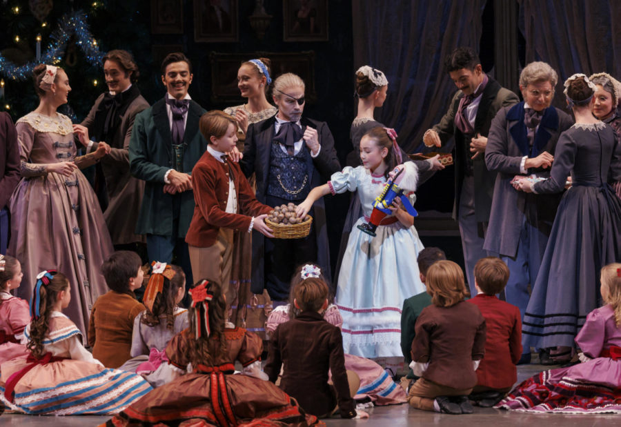 Clockwise from center: Adam Hendrickson as Herr Drosselmeier, Caroline O'Hagan as Marie and Titus Landegger as Herr Drosselmeier's nephew. Children are students of the School of American Ballet.  The Nutcracker, choreography © The George Balanchine Trust. New York City Ballet, Saturday, November 26, 2022, 8pm. Credit Photo: Erin Baiano