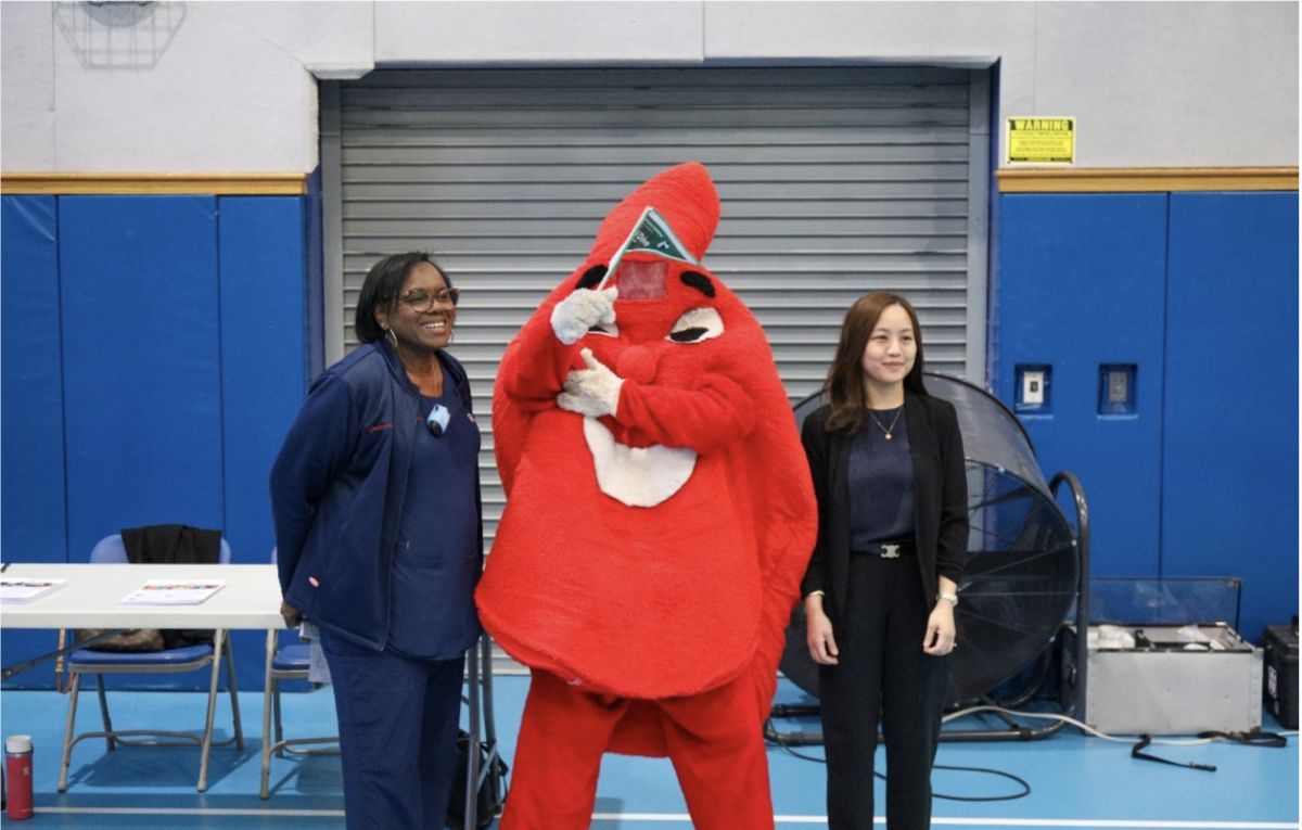 Bronxville Student, Cooper Caruso, wearing the NYBC mascot costume with two NYBC employees.

Photograph by Zeke Malpass
